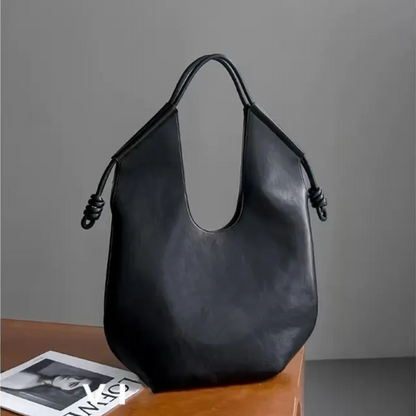 Clara is an elegant and spacious vegan leather tote bag.
