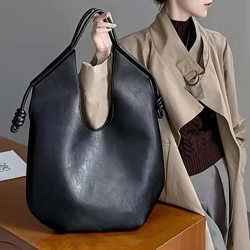 Clara is an elegant and spacious vegan leather tote bag.