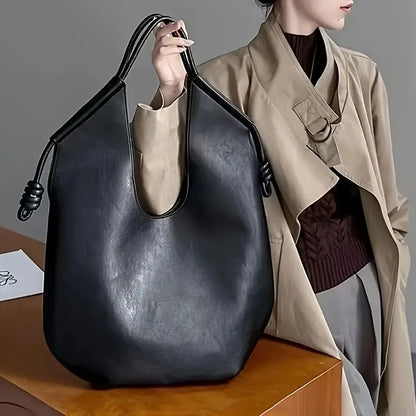 Clara is an elegant and spacious vegan leather tote bag.