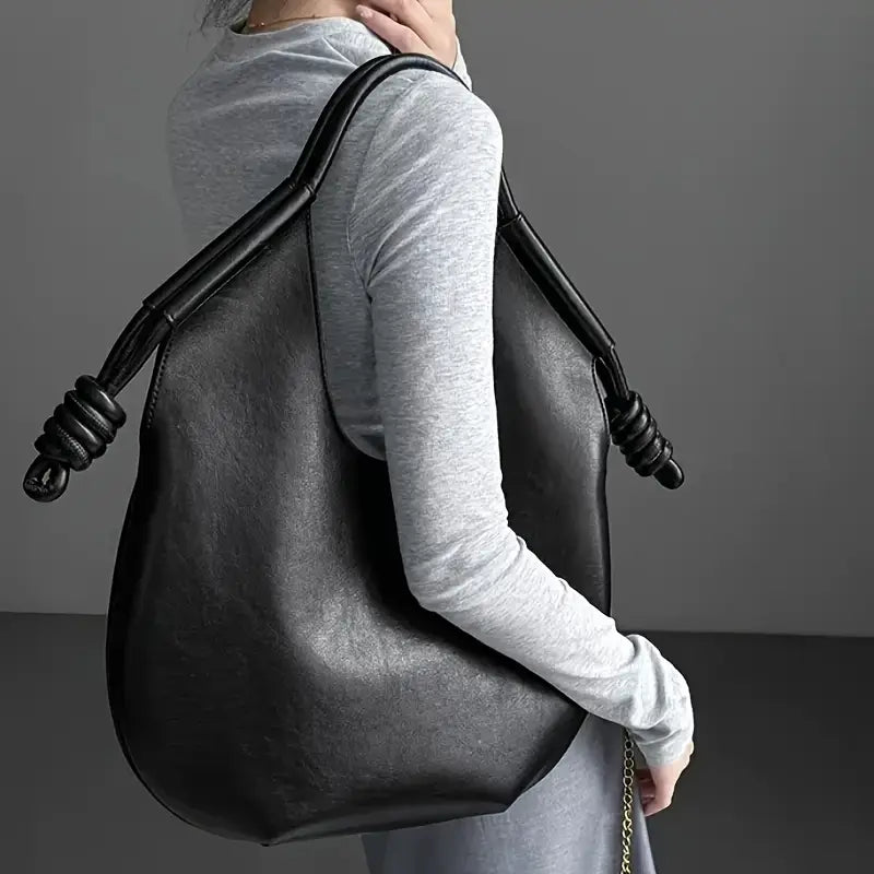 Clara is an elegant and spacious vegan leather tote bag.